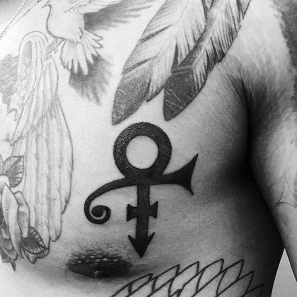 A bold chest tattoo of Prince's iconic Love Symbol, surrounded by angelic wings and feather details