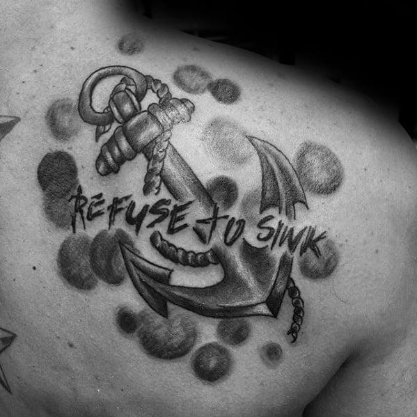 Black and gray tattoo of a detailed anchor with rope and the phrase "Refuse to Sink" in bold script