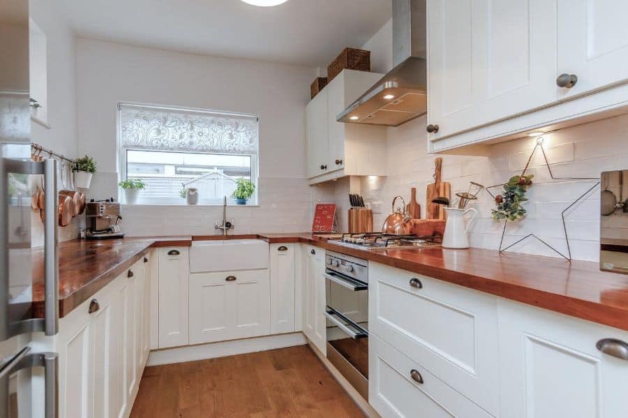 pattern valance kitchen window white cabinets wood countertop