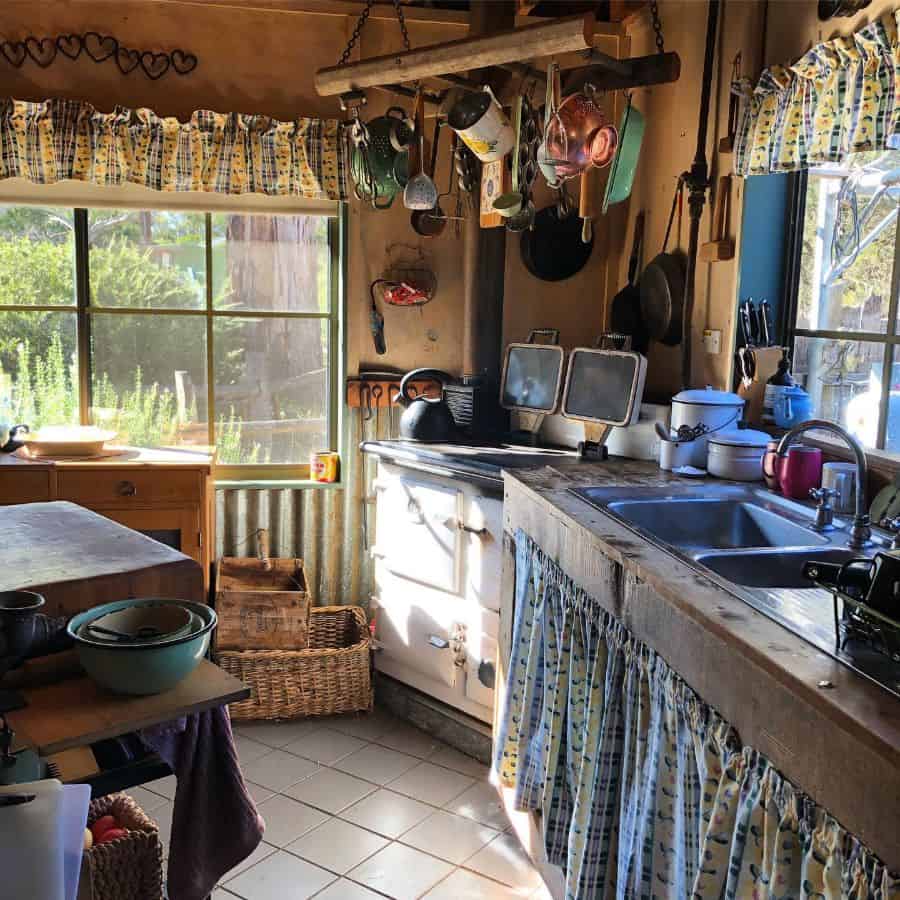 rustic kitchen wood countertop vintage stove flower print window valance