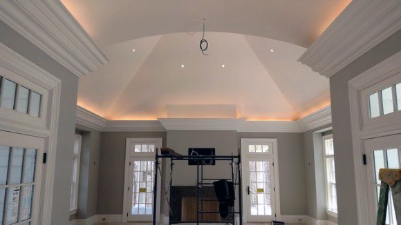 Sophisticated vaulted ceiling with crown molding lighting, offering an elegant and airy feel to the room
