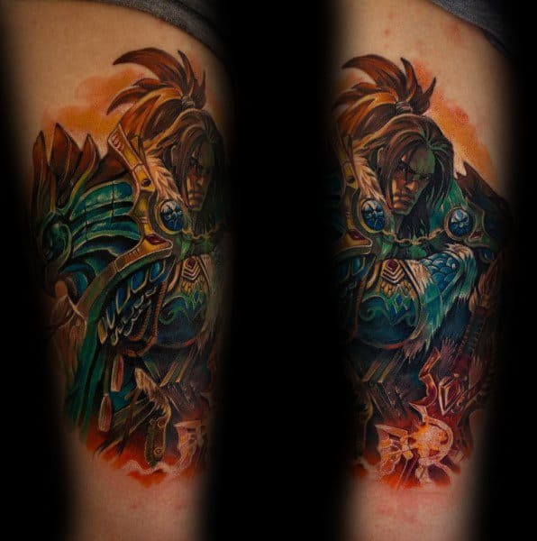 Vibrant tattoo of a heavily armored warrior from World of Warcraft, featuring intricate blue and gold armor, intense shading, and fiery background effects, inked on the arm.