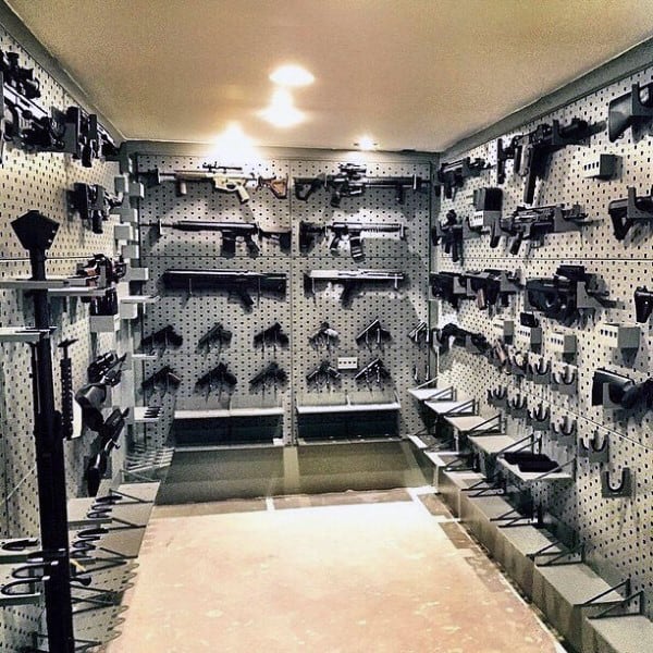 Gun room with pegboard walls featuring firearms, accessories, and secured storage racks.