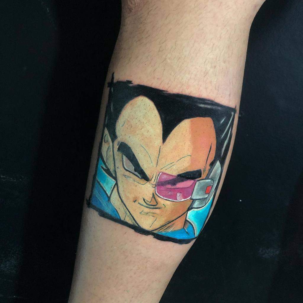 A tattoo of Vegeta from Dragon Ball, featuring his iconic purple scouter and determined expression, framed within a square design.