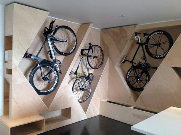 Custom wooden bike wall with geometric vertical storage for three bikes.