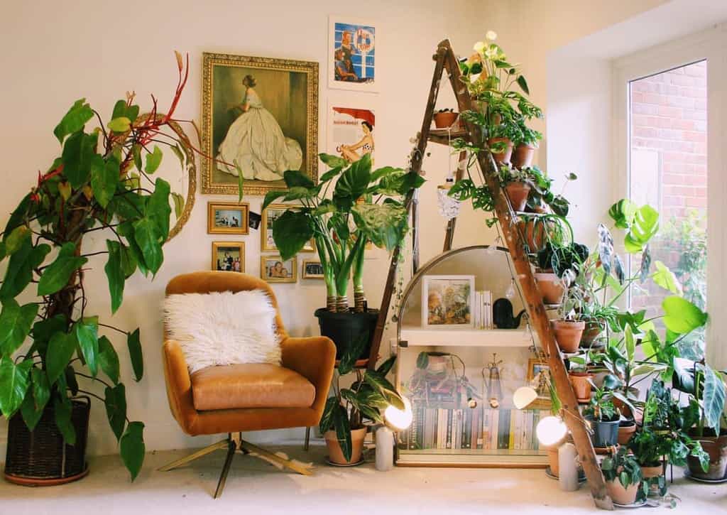 old ladder used as a planter accent chair framed artwork 