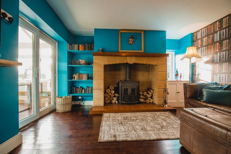 vibrant blue living room with old fashioned fireplace