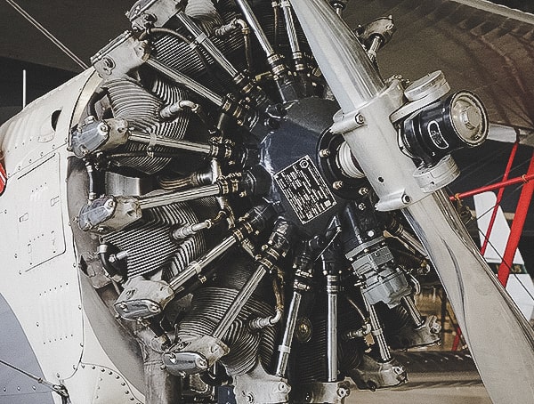 Vintage Aircraft Engine With Propeller Wings Over The Rockies