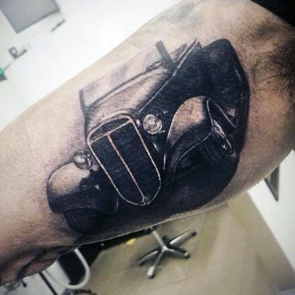 Tattoo of a vintage car on a bicep