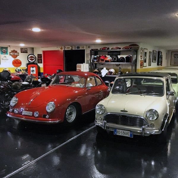 A charming dream garage featuring classic vintage cars, including a red Porsche 356 and a white Mini Cooper, surrounded by nostalgic decor.