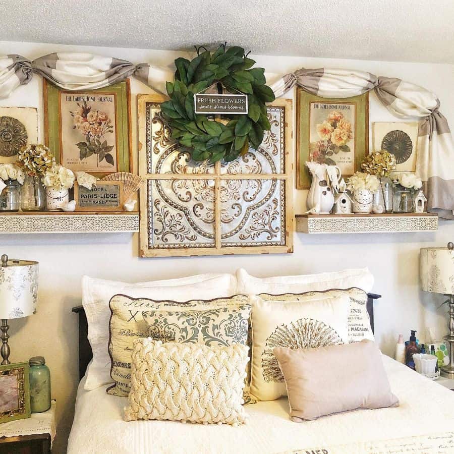 Cozy farmhouse bedroom with floral decor, vintage wall art, pillows, and a wreath above the bed