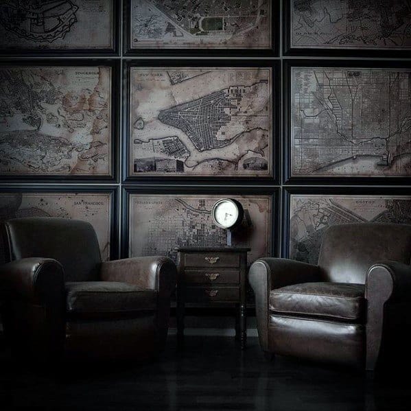 Framed vintage map wall art in a dark room with leather armchairs and a small side table.