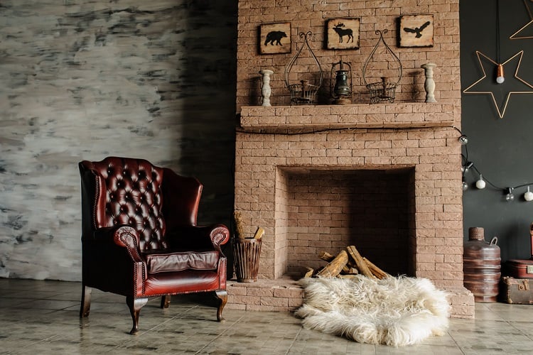 vintage leather armchair and stone fireplace