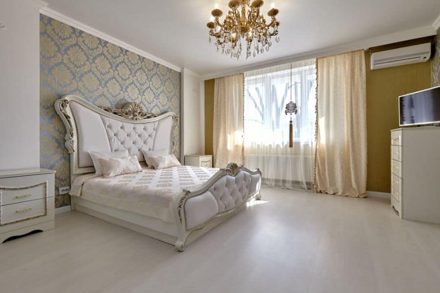 ornate bed in elegant bedroom with chandelier