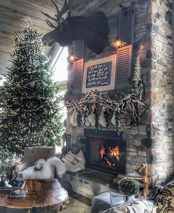Cozy rustic fireplace adorned with stockings, garlands, and vintage accents, creating a festive ambiance.