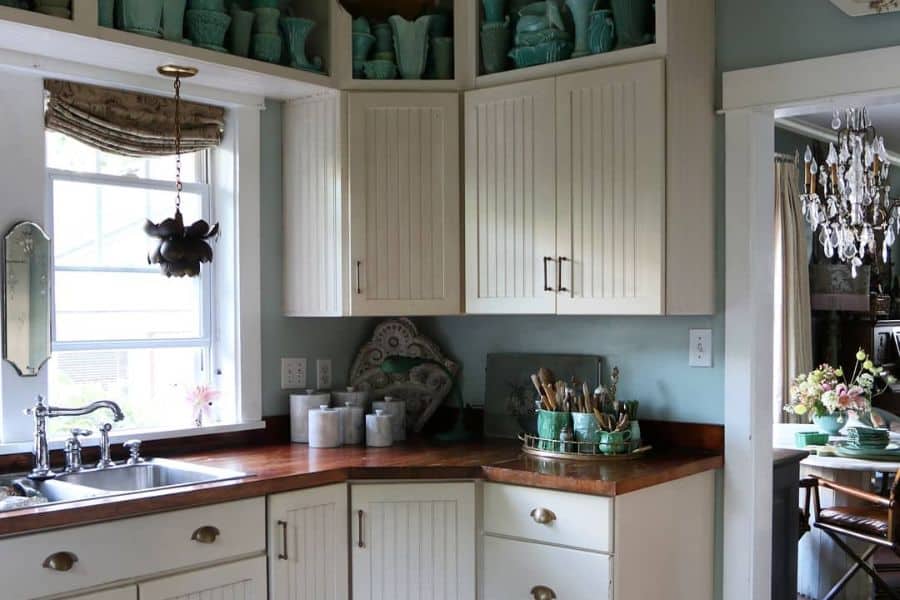 small corner vintage kitchen with white cabinets