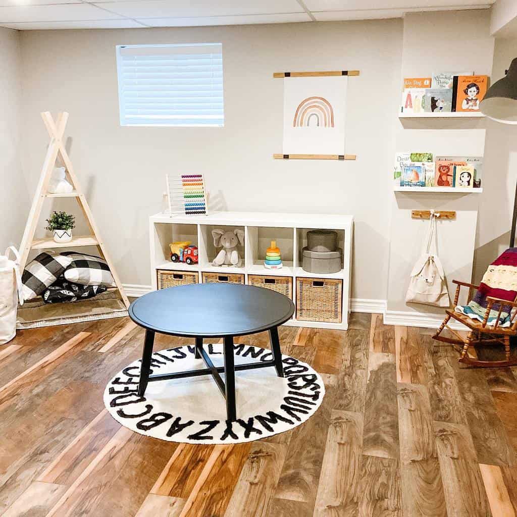 Children's playroom with wooden floorboards, alphabet rug, toy storage shelves, and minimalist decor with wall art and a reading nook.