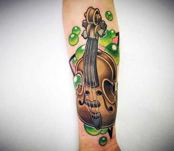 Colorful new school-style tattoo of a violin on the forearm, featuring bold outlines, exaggerated shading, and vibrant green bubble accents.