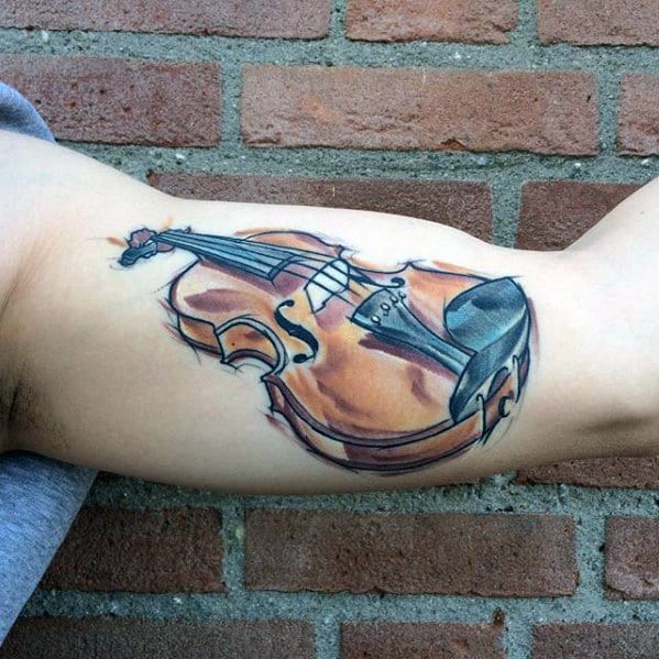 Realistic violin tattoo with soft watercolor-style shading and subtle blue accents, placed on the inner bicep for a flowing, artistic look.