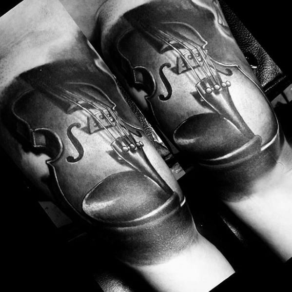 Black and gray tattoo of a detailed violin across both forearms, creating a complete instrument when the arms are placed side by side.