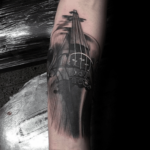 Realistic black and gray violin tattoo with motion-blur effects on the strings and bow, creating a dynamic and dramatic forearm design.