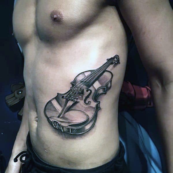 Realistic black and gray violin tattoo on the side torso, featuring detailed shading and depth to give the instrument a three-dimensional appearance.