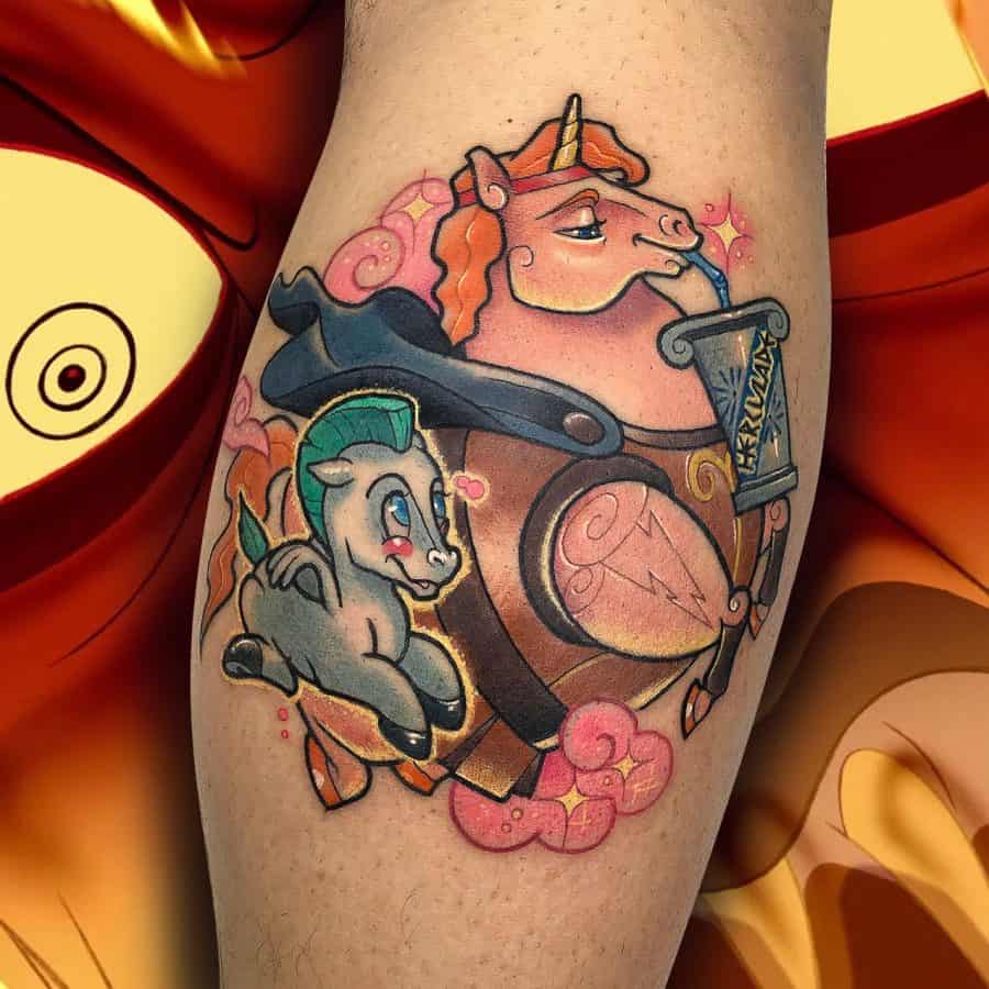Colorful tattoo of a warrior unicorn in armor holding a scroll, accompanied by a small Pegasus, featuring bold outlines and vibrant hues.