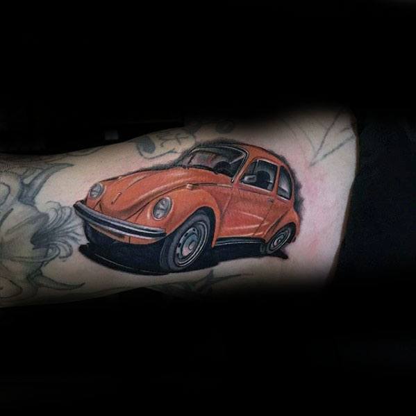 Vibrant orange Volkswagen Beetle tattoo on the inner arm, with clean shading and a playful, nostalgic look.
