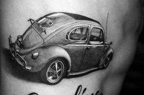 Realistic black and gray tattoo of a classic Volkswagen Beetle, showing a detailed rear-side view with fine linework and shading.