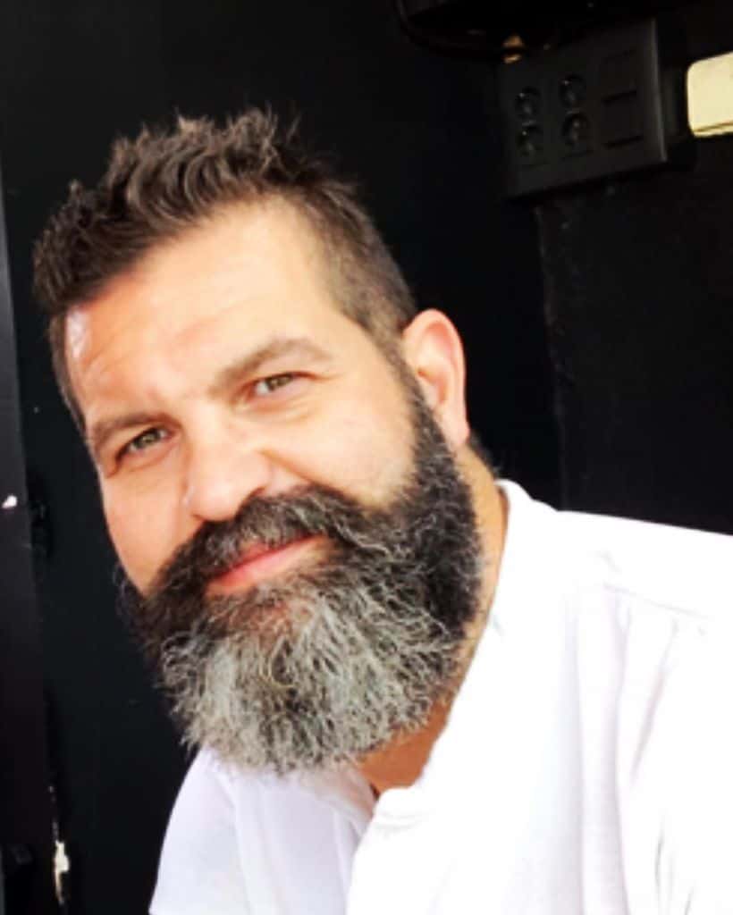 A man with a well-groomed full beard