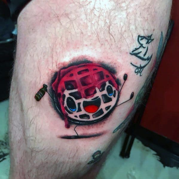 Cute animated waffle tattoo with a smiling face, bright blue eyes, raspberry syrup, and tiny syrup bottle, creating a fun and playful breakfast design.