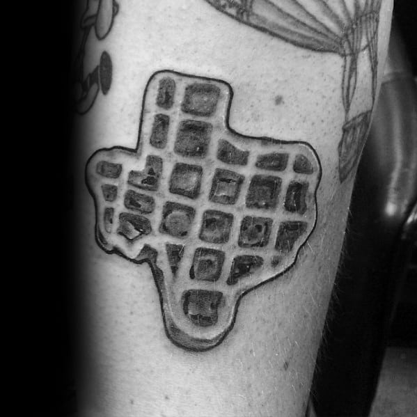 Black and gray Texas-shaped waffle tattoo with bold shading and texture, combining state pride with a creative breakfast-inspired design.
