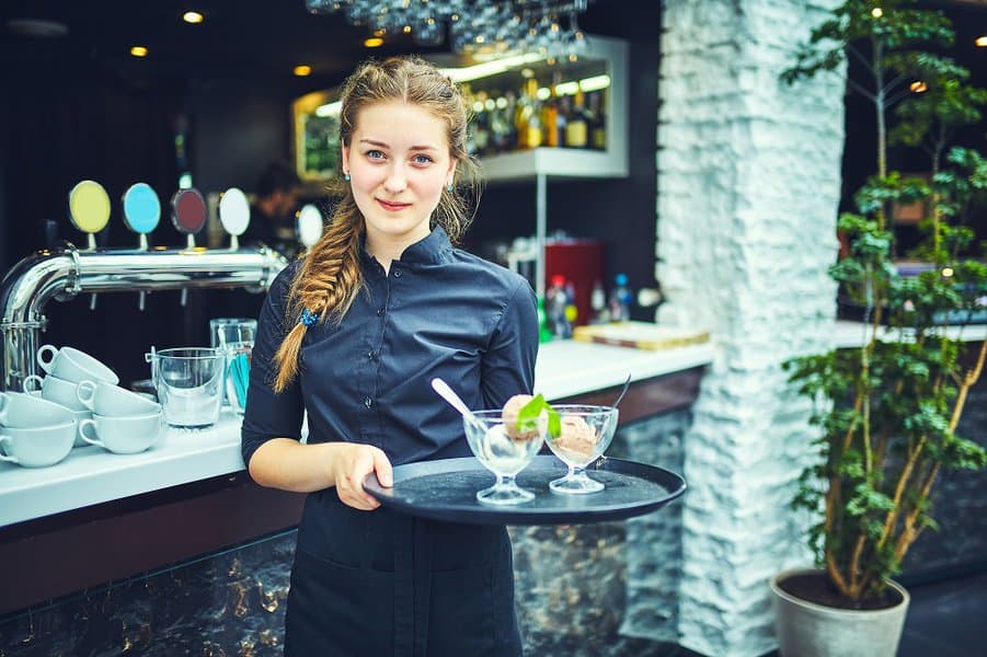 waitress carrying dish in a restaurant