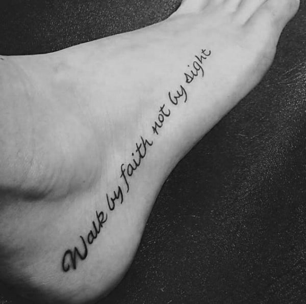 Foot tattoo with "Walk by Faith, Not by Sight" in a flowing cursive script, elegantly placed along the arch for a subtle yet powerful message.