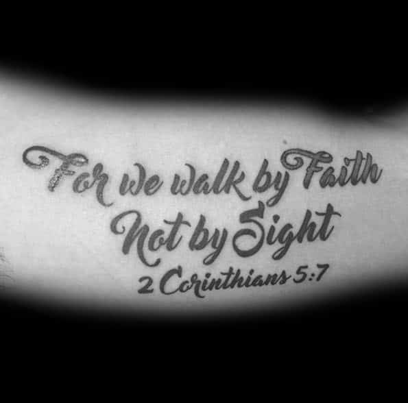 Tattoo featuring the Bible verse 2 Corinthians 5:7 in elegant script, stating For we walk by Faith, Not by Sight, symbolizing strong belief.