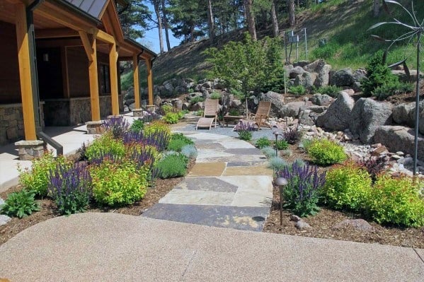 colorful backyard with stone pathway wood sun lounges 