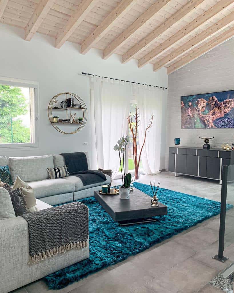 modern living room with gray sofa blue floor rug white curtains