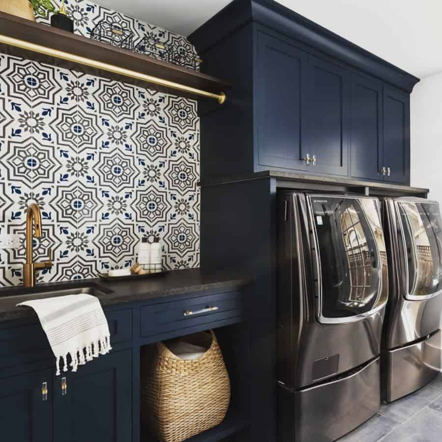 blue cabinet pattern tile laundry with washer and dryer 
