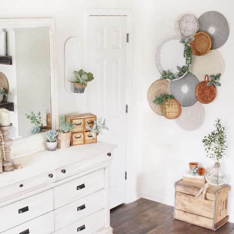 white vintage farmhouse bedroom with cabinet and wall decor