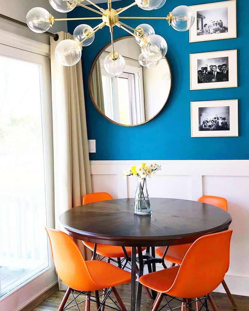 blue accent wall dining room with framed wall photos