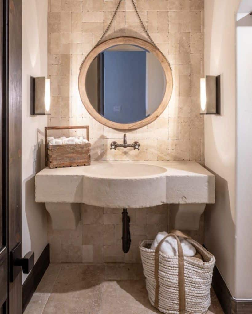 white powder room with circular mirror 
