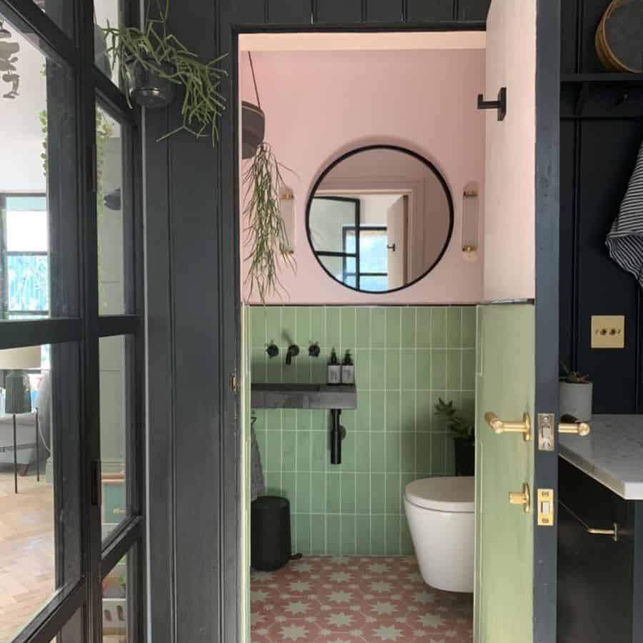 pink and green powder room with black accents 