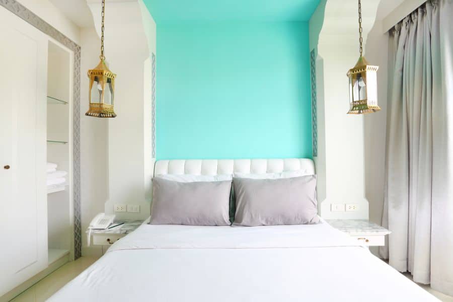 turquoise accent wall in small master bedroom with lamp ceiling lights