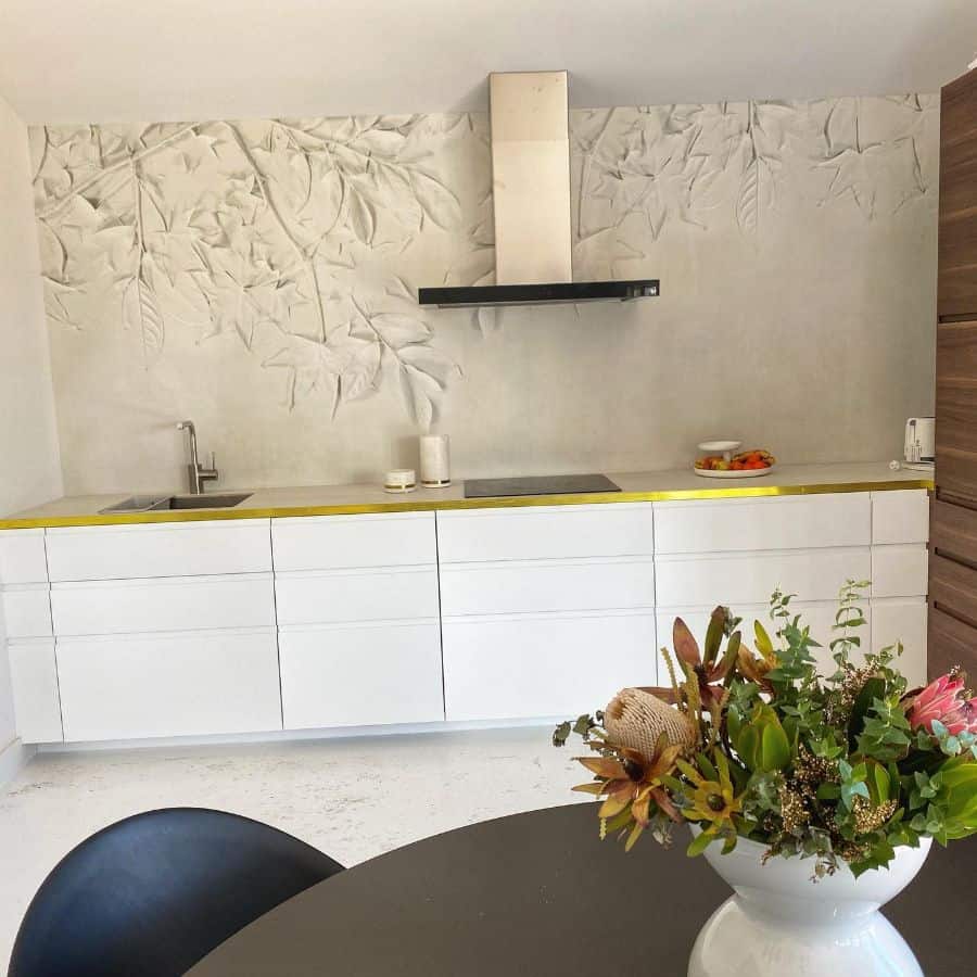 stylish modern kitchen with white cabinets and textured wall