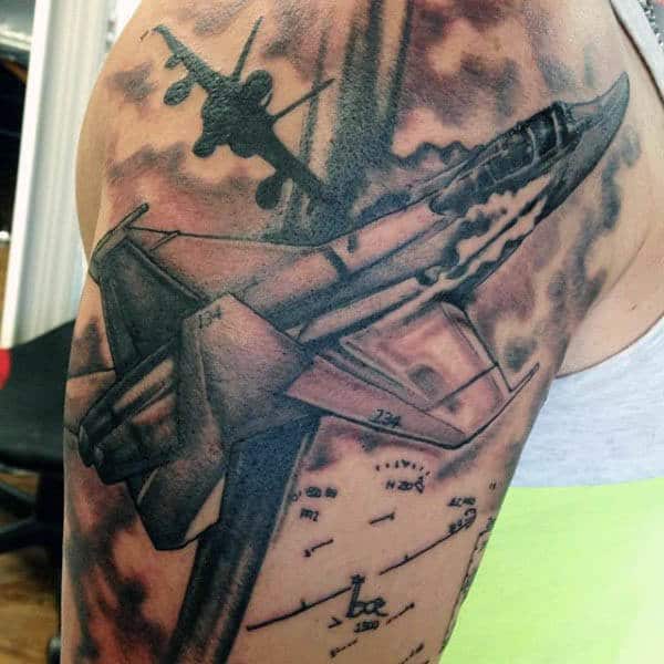 Tattoo of fighter jets and an airplane on an upper arm, one in flight with sky and cloud details