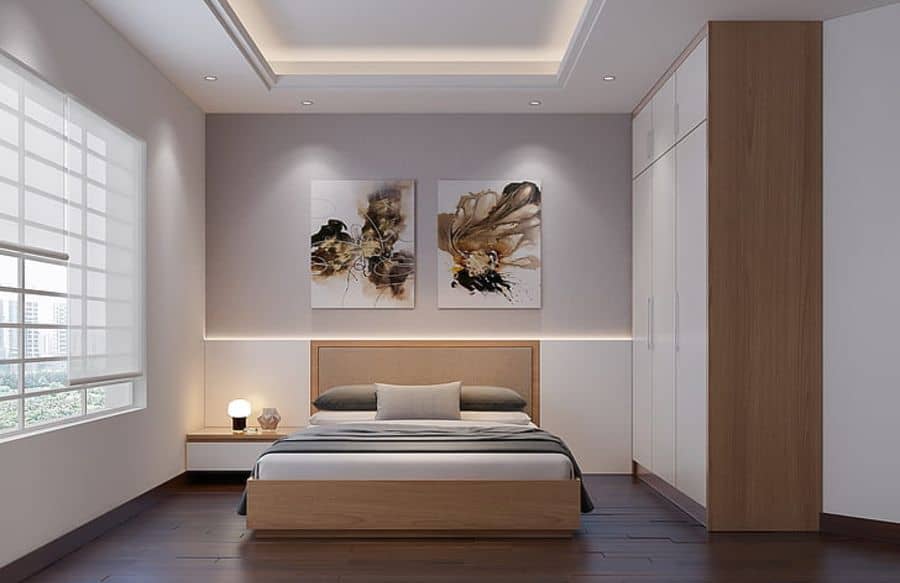 Sleek contemporary bedroom with white closets and abstract wall art.