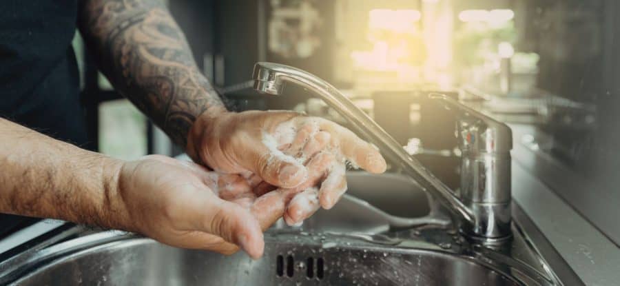 Washing Hands Under Tattoo With Soap