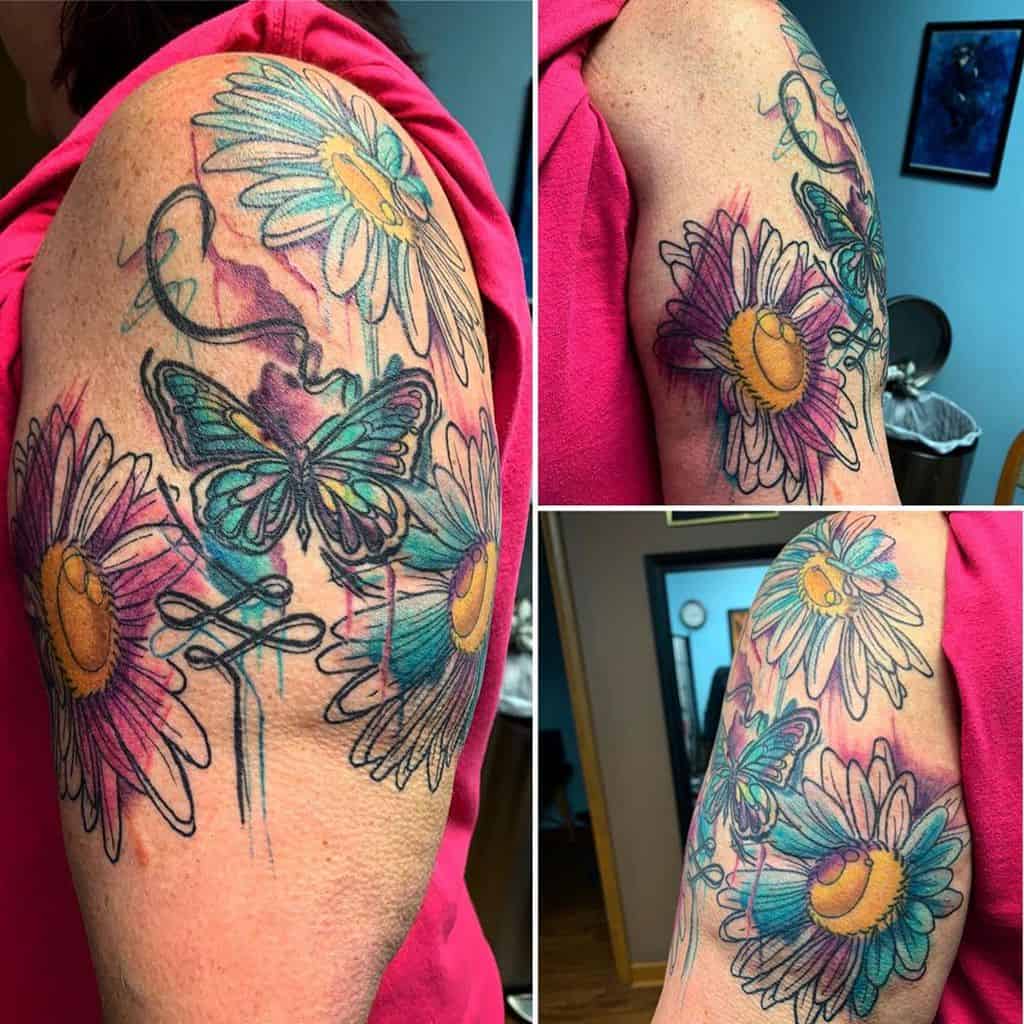 Upper arm tattoo water color daisy and butterfly
