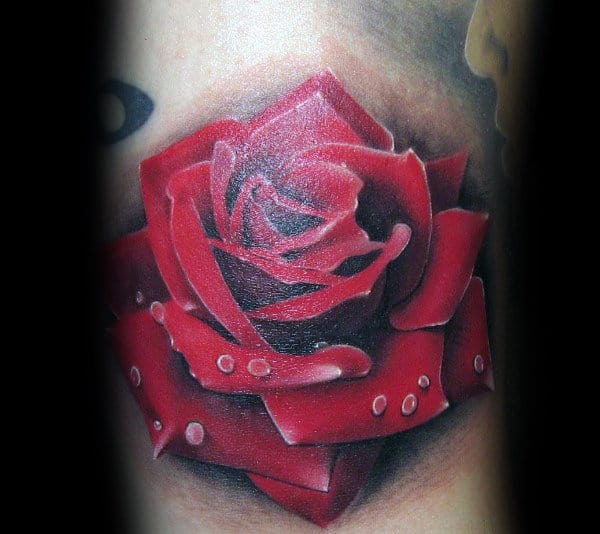 Tattoo of a vibrant red rose with water droplets on petals