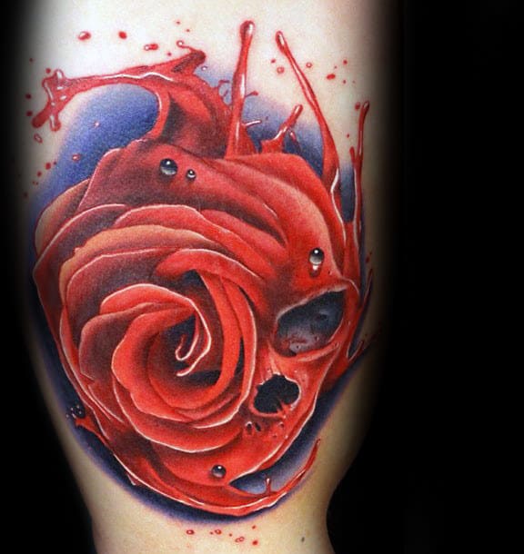 Tattoo of a red rose merging with a skull 